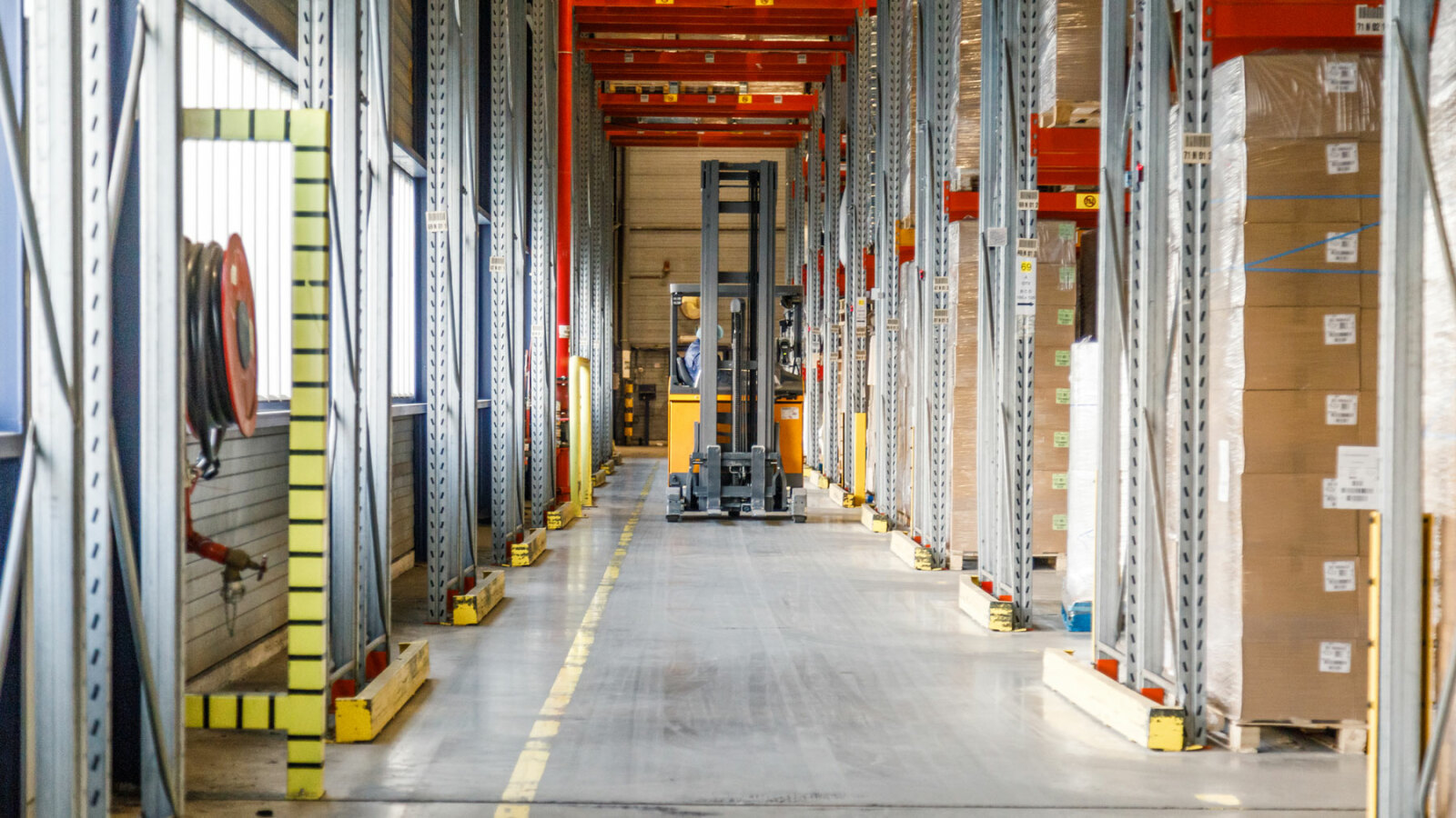 forklift driving through warehouse
